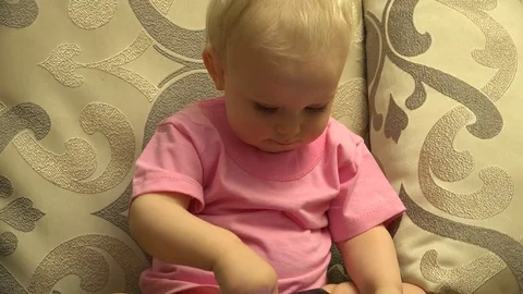 Smart Little Girl Using Tablet Computer while Sitting on Couch. 4K UltraHD, UHD Vídeos de archivo 82461794