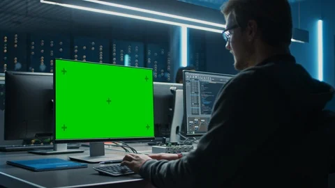 Smart Male IT Programer Working on Desktop Green Mock-up Screen Computer in Data Stock Footage 103268309