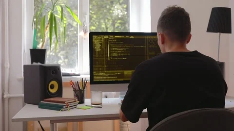 Smart man programmer working at home in loft room writing programming code for Stock Footage 115491669