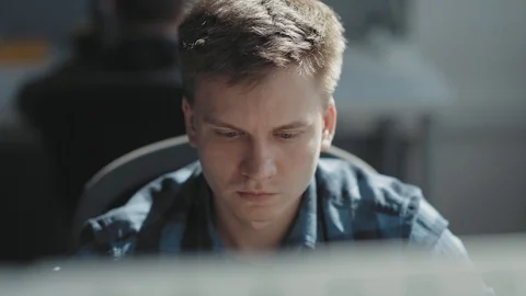 Smart man is sitting in front of a computer 库存影片 117537027