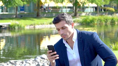 Smart man texting outside in a park 4K Stock Footage 96062294