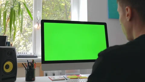 Smart man working at home in loft room on personal computer with green screen Stock Footage 116334988