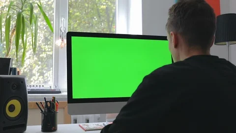 Smart man working at home in loft room on personal computer with green screen Stock Footage 116335266