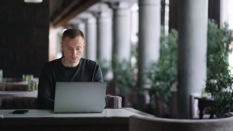 Smart Man Working With Laptop In Cafe, Portrait Of Young Adult Freelancer With Stock Footage 247413183
