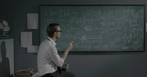 Smart mathematician reviewing math formulas on the chalkboard Stock Footage 139260343
