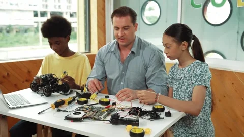 Smart mentor teach about electronic equipment while fix car model. Edification Stock Footage 265498946