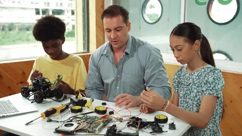 Smart mentor teach about electronic equipment while fix car model. Edification Stock Footage 283794408