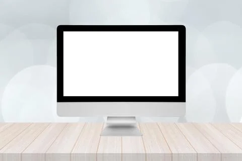 Smart modern pc with blank white screen on wooden table and modern bokeh wall Stock Photos