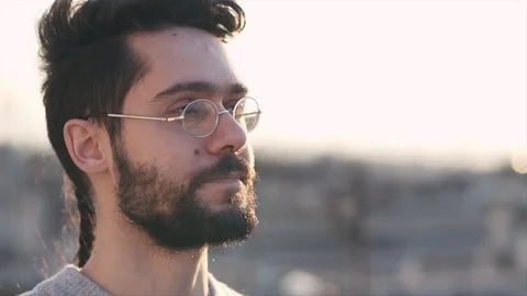 Smart Modern Young Man Wearing Glasses, On Rooftop of a building, before Suns Stock Footage 106635693