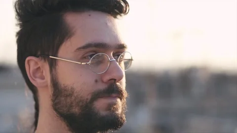 Smart Modern Young Man Wearing Glasses, On Rooftop of a building, before Suns Видео 106635694