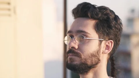 Smart Modern Young Man Wearing Glasses, On Rooftop of a building, before Suns 库存影片 106635790