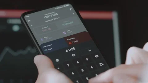 Smart money management. Using technology to track budget. A person who uses a Stock Footage 250383259