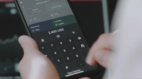 Smart money management. Using technology to track budget. A person who uses a Stock Footage 250383615