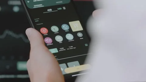 Smart money management. Using technology to track budget. A person who uses a Stock Footage 250383795