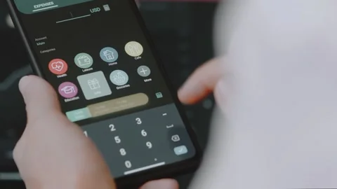 Smart money management. Using technology to track budget. A person who uses a Stock Footage 250383851