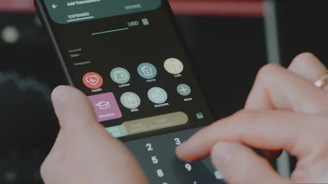 Smart money management. Using technology to track budget. A person who uses a Stock Footage 250383993