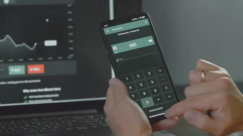 Smart money management. Using technology to track budget. A person who uses a Stock Footage 250384842
