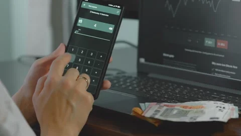 Smart money management. Using technology to track budget. A person who uses a Stock Footage 250384900
