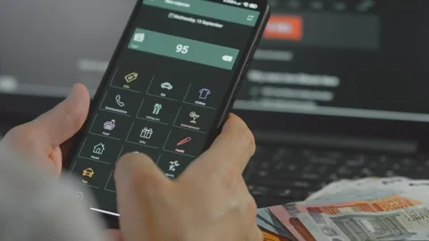 Smart money management. Using technology to track budget. A person who uses a Stock Footage 250385046