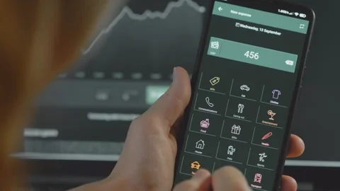 Smart money management. Using technology to track budget. A person who uses a Stock Footage 250386062