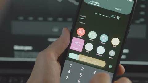 Smart money management. Using technology to track budget. A person who uses a Stock Footage 250386454