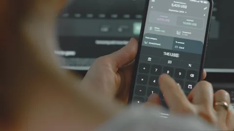 Smart money management. Using technology to track budget. A person who uses a Stock Footage 250386517