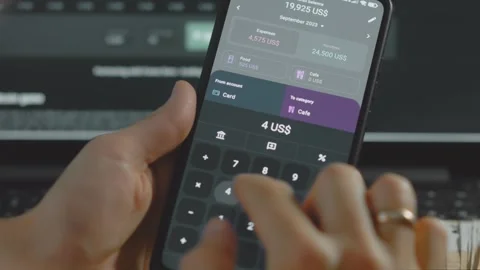 Smart money management. Using technology to track budget. A person who uses a Stock Footage 250386878