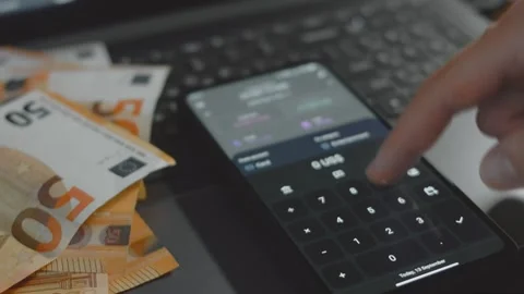 Smart money management. Using technology to track budget. A person who uses a Stock Footage 250387091