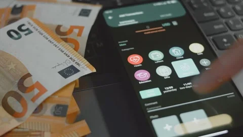 Smart money management. Using technology to track budget. A person who uses a Stock Footage 250387394