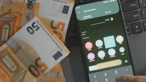 Smart money management. Using technology to track budget. A person who uses a Stock Footage 250387827