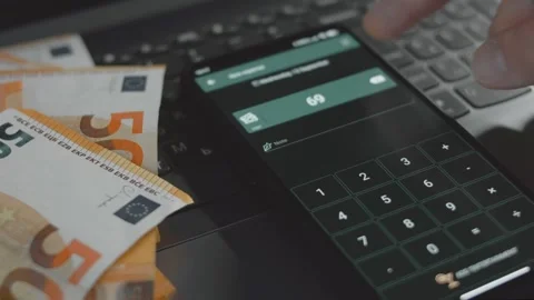 Smart money management. Using technology to track budget. A person who uses a Stock Footage 250387930