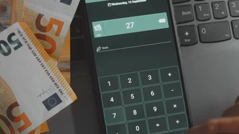Smart money management. Using technology to track budget. A person who uses a Stock Footage 250388155