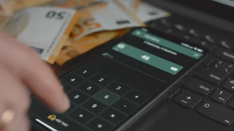 Smart money management. Using technology to track budget. A person who uses a Stock Footage 250388194