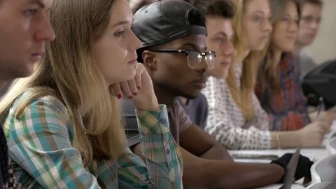Smart multi-ethnic students listening and looking at speaker Stock Footage 69927768