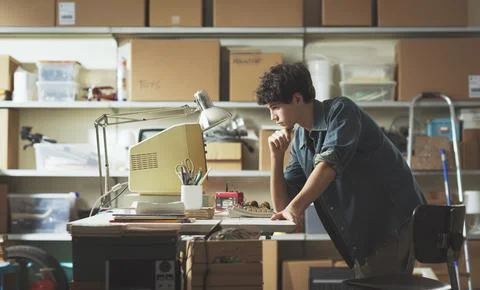 Smart nerd adolescent working with an old PC 스톡 사진