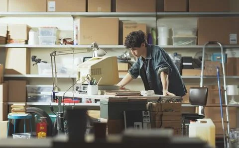Smart nerd adolescent working with an old PC 스톡 사진