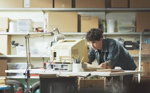 Smart nerd adolescent working with an old PC 스톡 사진