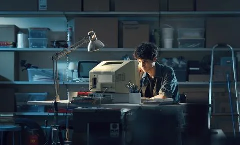 Smart nerd guy using a computer in the garage Stock Photos