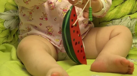 Smart Newborn Playing with a Watermelon Like Toy. 4K UltraHD, UHD Stockbeeldmateriaal 61103786