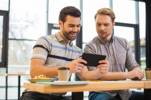 Smart nice men having lunch in the cafe Stock Photos