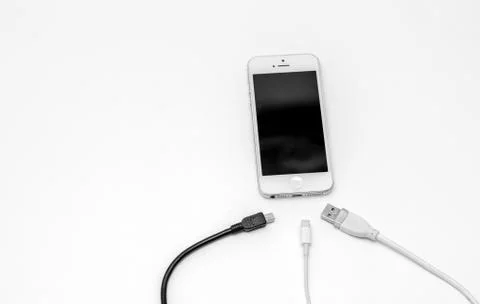 Smart phone and adapter cable Stock Photos