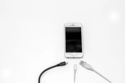 Smart phone and adapter cable Stock Photos