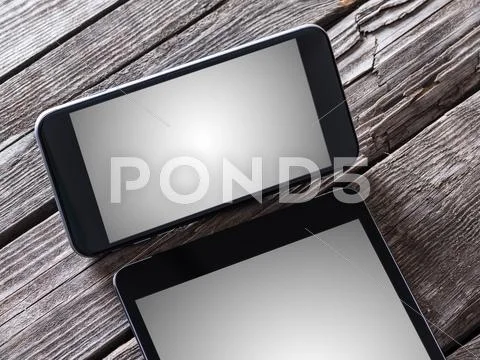 Smart Phone And Tablet Pc On A Desktop. Clipping Paths Included