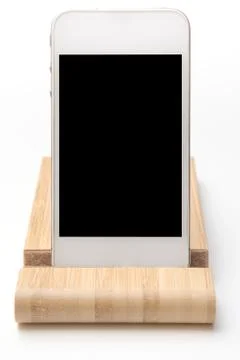 Smart phone and tablet wireless charging on a white desk Stock Photos