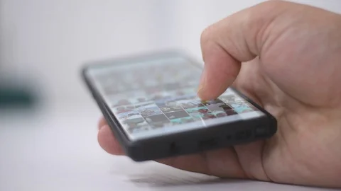 Smart phone and Technology Concept: Young man tourning his phone on the table Stock Footage 125524291