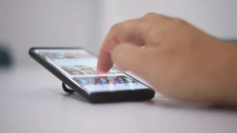 Smart phone and Technology Concept: Young man tourning his phone on the table Stock Footage 125524549