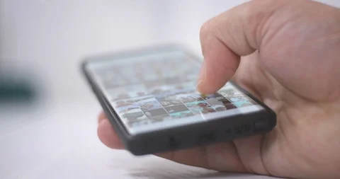 Smart phone and Technology Concept: Young man tourning his phone on the table Stock Footage 125653774