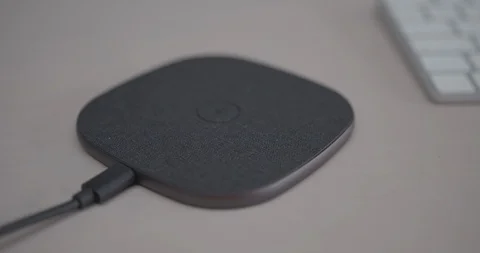 Smart Phone battery charged on wireless charger Video stock 124660011