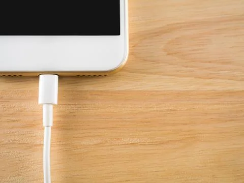 Smart phone charging with USB cable Stock Photos