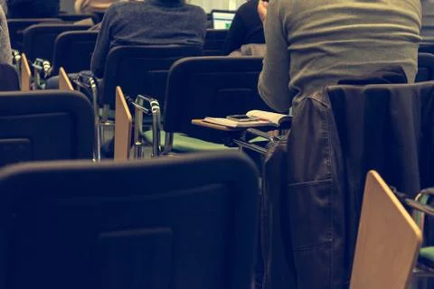 Smart phone on classroom table. Stock Photos